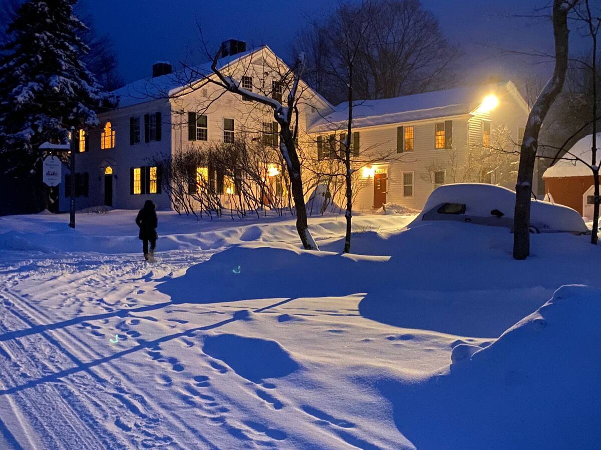 The inn on a winter evening, windows lit